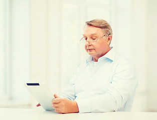 Image showing old man with tablet computer at home