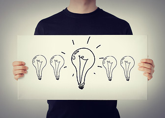 Image showing man showing picture with light bulbs