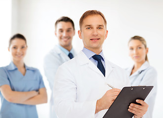 Image showing smiling male doctor with clipboard