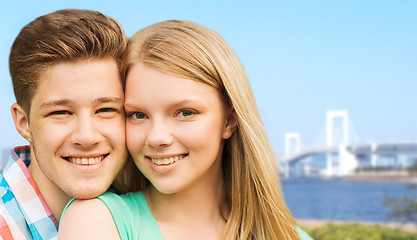 Image showing smiling couple over rainbow bridge in tokyo