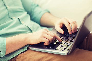 Image showing close up of man working with laptop at home