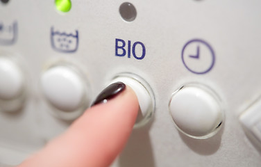 Image showing close up of woman finger pressing washer button