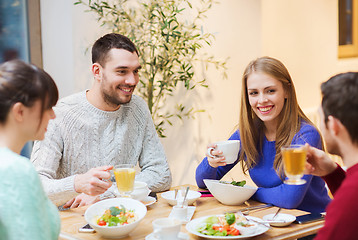 Image showing happy friends meeting and having dinner at cafe