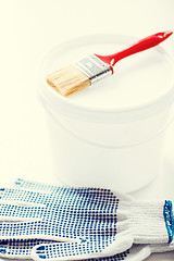 Image showing paintbrush, paint pot and gloves