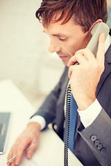 Image showing businessman with laptop computer and phone