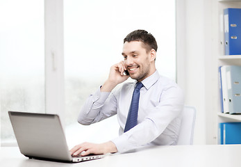 Image showing businessman with laptop and smartphone at office