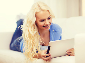 Image showing smiling woman with tablet pc computer at home