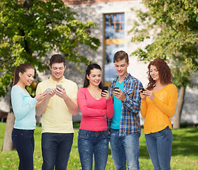 Image showing group of smiling teenagers with smartphones