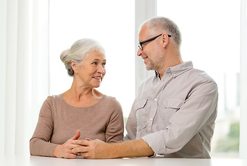 Image showing happy senior couple sitting on sofa at home