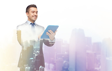 Image showing happy businessman in suit holding tablet pc