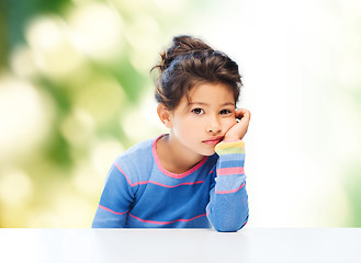 Image showing sad little girl over city background