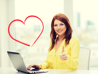 Image showing smiling student with laptop computer at school