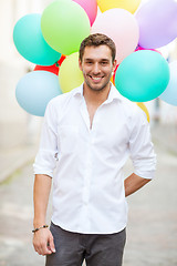 Image showing man with colorful balloons in the city