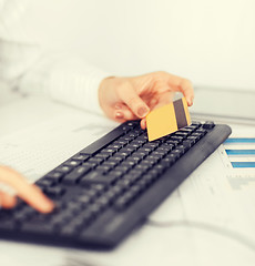 Image showing businesswoman with laptop using credit card