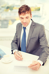 Image showing businessman with laptop computer and documents