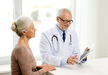 Image showing smiling senior woman and doctor with tablet pc