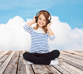 Image showing happy girl with headphones listening to music