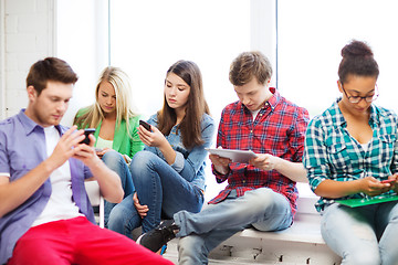 Image showing students looking into devices at school