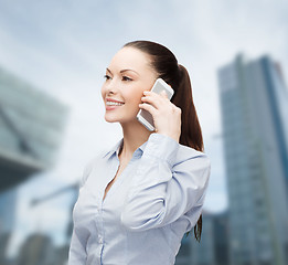 Image showing young smiling businesswoman with smartphone