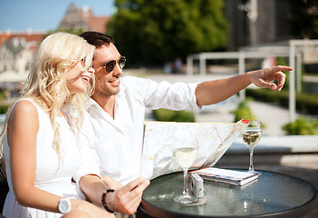 Image showing couple with map in cafe