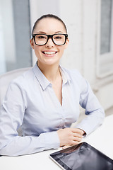 Image showing smiling businesswoman in eyeglasses with tablet pc