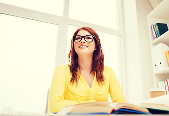 Image showing young woman reading book at school