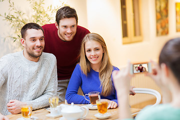 Image showing group of friends taking picture with smartphone