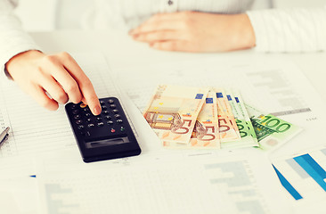 Image showing woman hand with calculator and euro money