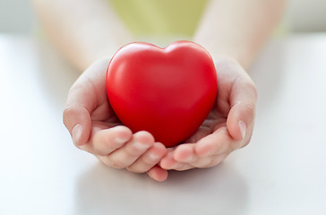 Image showing close up of child hands holding red heart