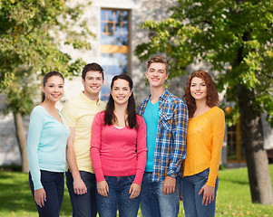 Image showing group of smiling teenagers over campus background