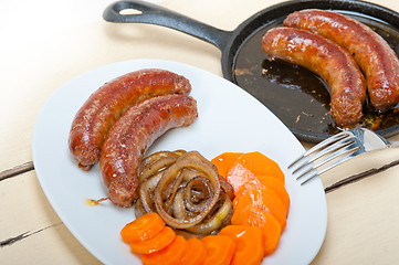 Image showing beef sausages cooked on iron skillet 