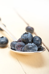 Image showing fresh blueberry on silver spoon