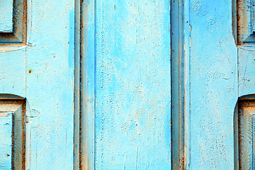 Image showing stripped paint in the blue wood door and  