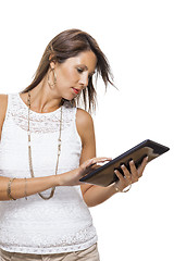 Image showing Woman chatting on a mobile while reading a tablet