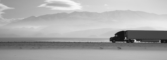 Image showing Semi Truck Travels Highway Over Salt Flats Frieght Transport