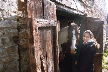 Image showing Teenage girl with her beautiful horse friend