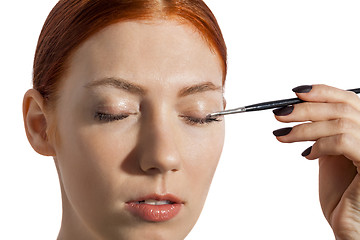 Image showing Pretty Woman Applying Eye Shadow Makeup