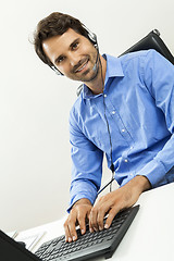 Image showing Man wearing headset giving online chat and support