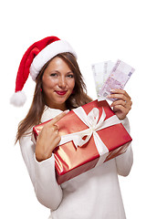 Image showing Young woman with an Xmas gift and money