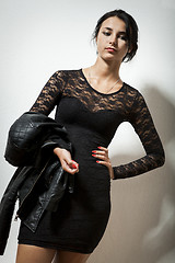Image showing Gorgeous Woman in Black Dress Carrying her Jacket