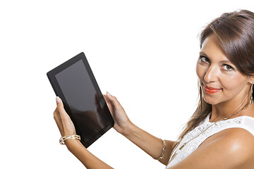 Image showing Woman chatting on a mobile while reading a tablet