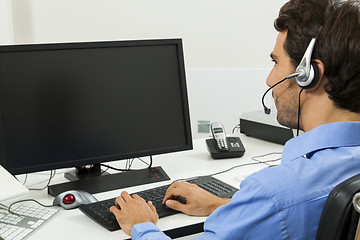 Image showing Man wearing headset giving online chat and support