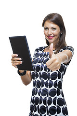 Image showing Smiling Woman in a Dress Holding a Tablet Computer