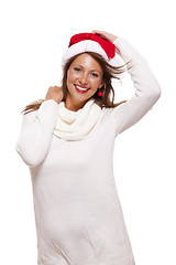 Image showing Young woman in a Santa hat holding out her hands