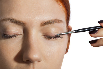 Image showing Pretty Woman Applying Eye Shadow Makeup