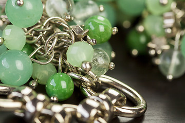 Image showing Green beads on an item of silver jewellery