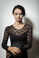 Image showing Gorgeous Woman in Black Dress Carrying her Jacket