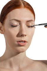 Image showing Pretty Woman Applying Eye Shadow Makeup