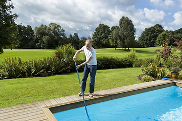 Image showing Man Cleaning Swimming Pool
