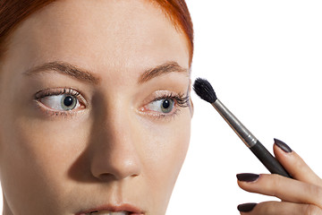 Image showing Pretty Woman Applying Eye Shadow Makeup